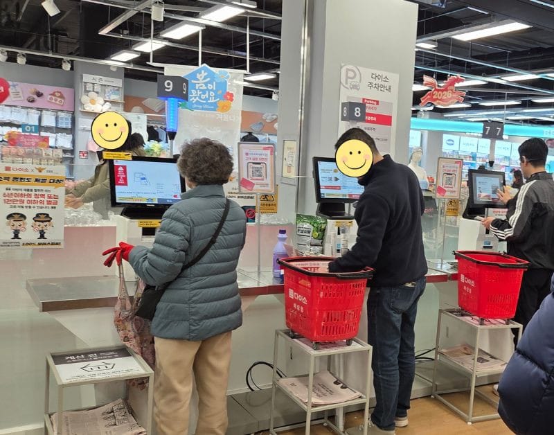 Customers using the numerous unmanned self-checkout kiosks at the Daiso Bongdam E-mart store.