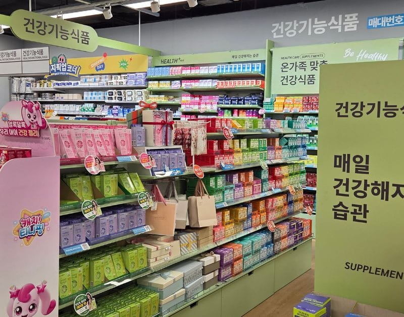 Daiso shelves neatly organized with vitamins, probiotics, and health supplements.