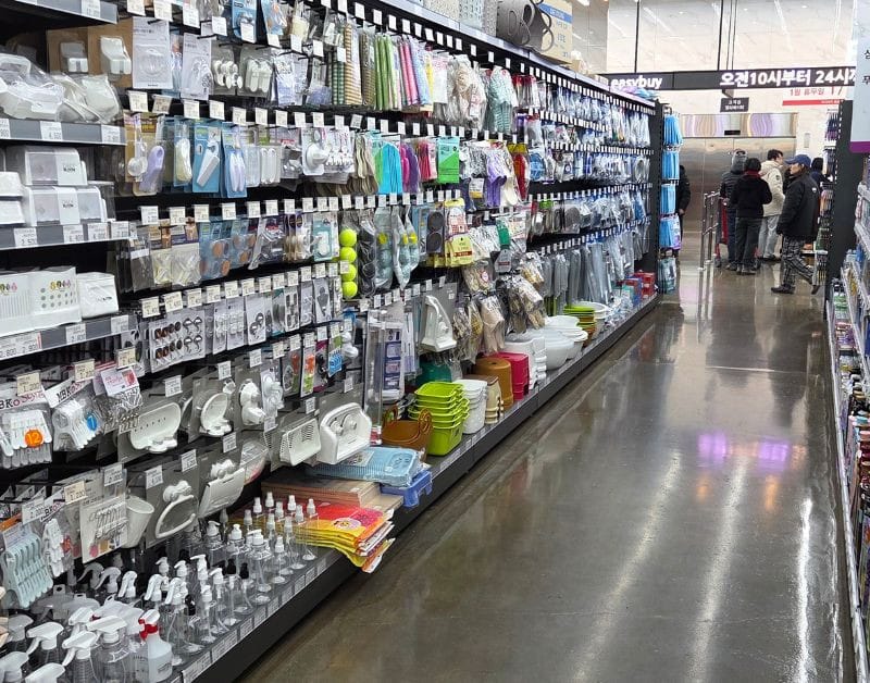 Wide and clean aisle stocked with household goods at Easy Buy Supermarket Bongdam.