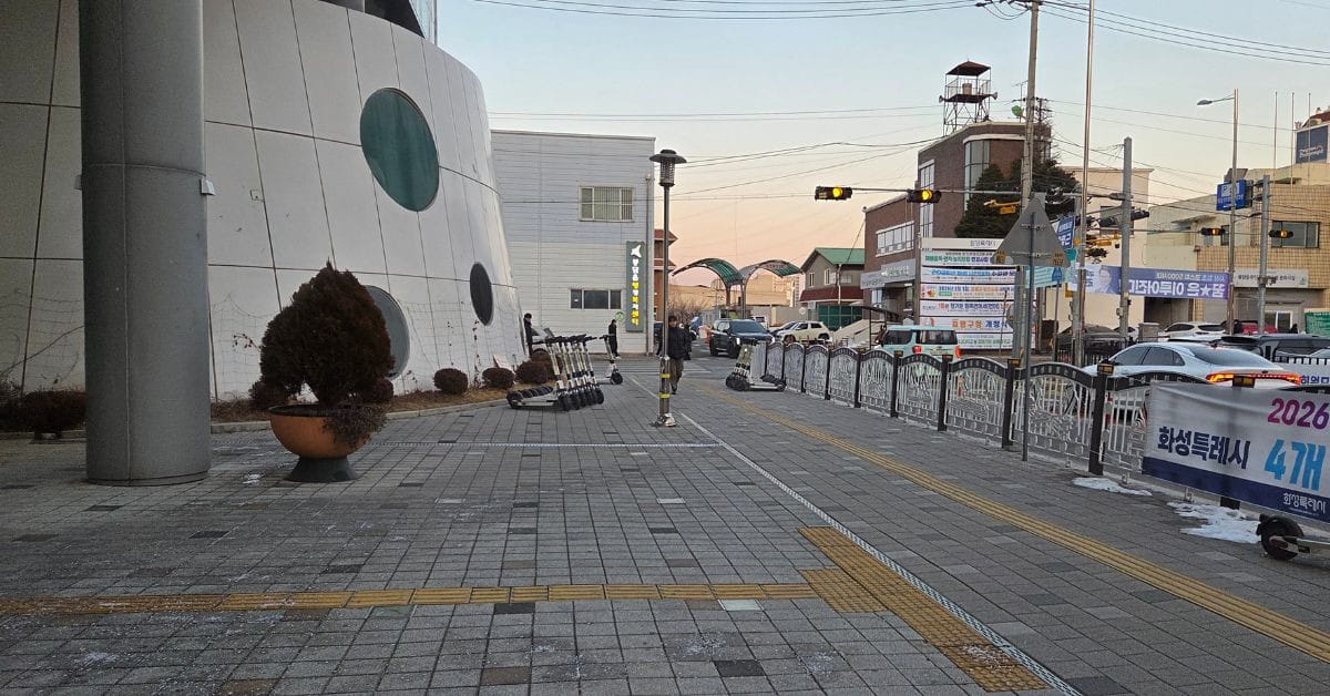 Exterior of Bongdam Library in Hwaseong with shared electric scooters parked on the sidewalk.