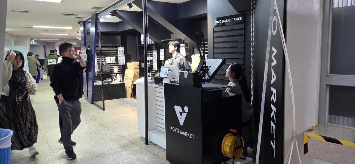 A stadium merchandise shop displays various team apparel and souvenirs.