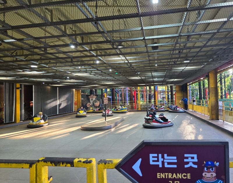 Families enjoying bumper cars at the Play Village amusement park section of the Korean Folk Village.