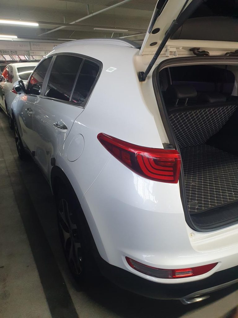 Rear exterior view of a parked car showing the bumper, taillights, and trunk area.