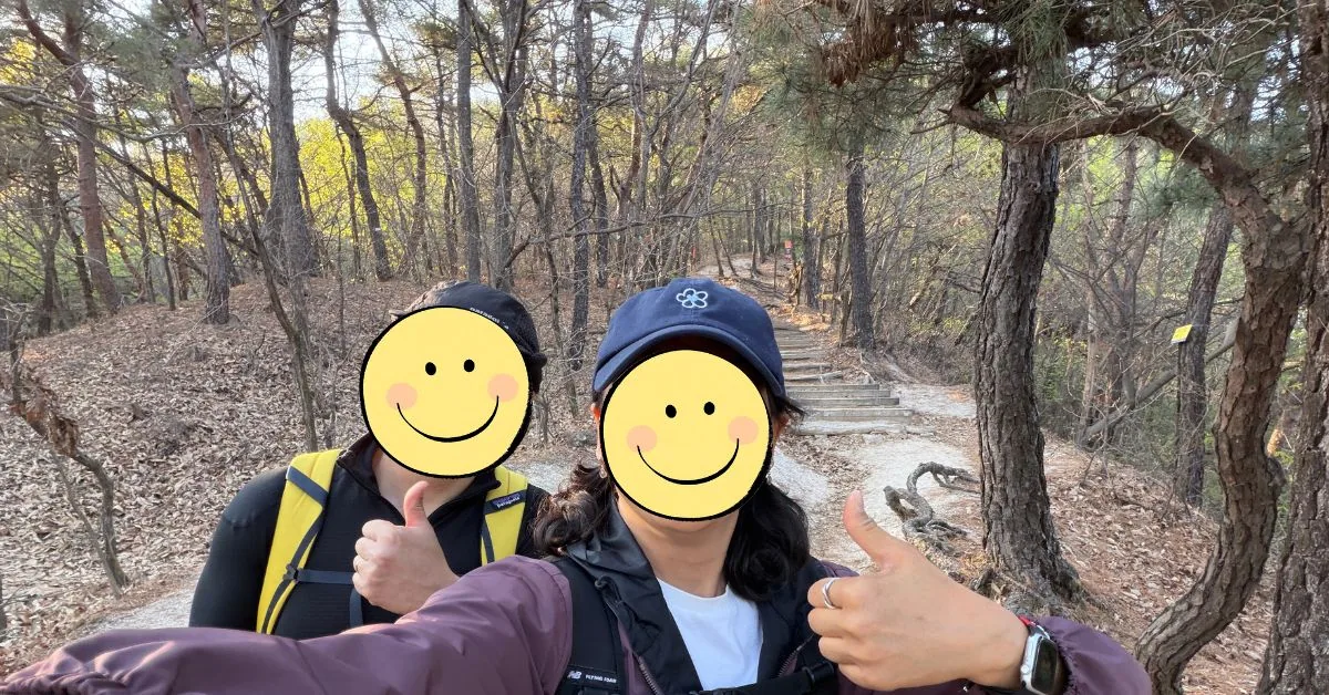 Hikers walking along a shaded dirt path on Seoul Trail Course 2.