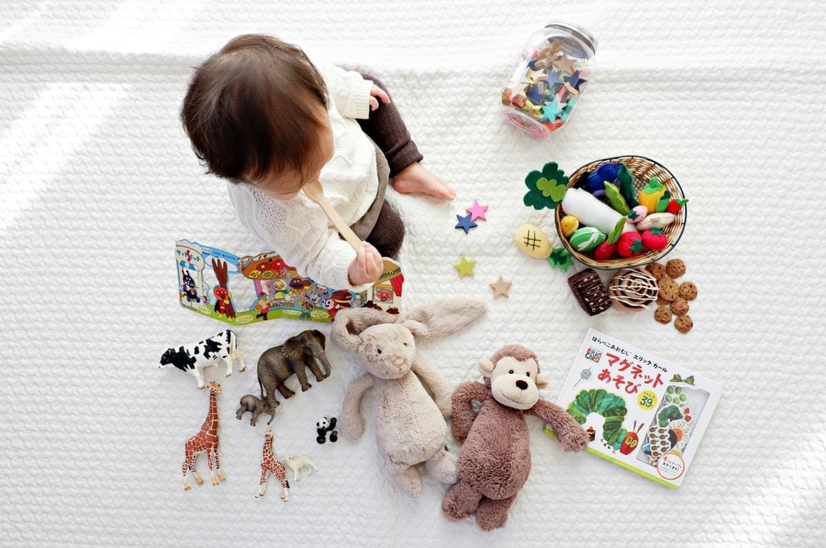 Various colorful baby toys sit on a flat surface.