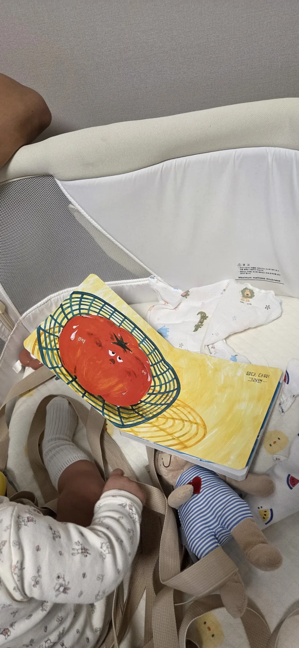 A young child happily engaging with a book through early childhood literacy programs South Korea.