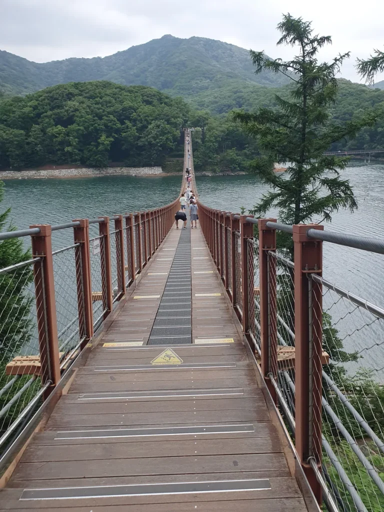 Walking across the Majang Lake suspension bridge wooden deck