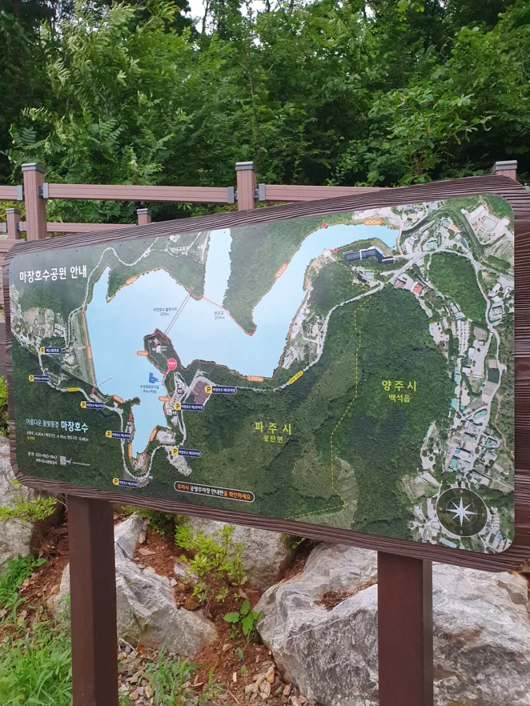 Wooden map board showing the 3.3km lakeside walking path at Majang Lake