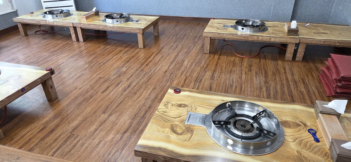 Traditional floor-sitting tables offer a cozy experience with ample Korean restaurant parking availability nearby.