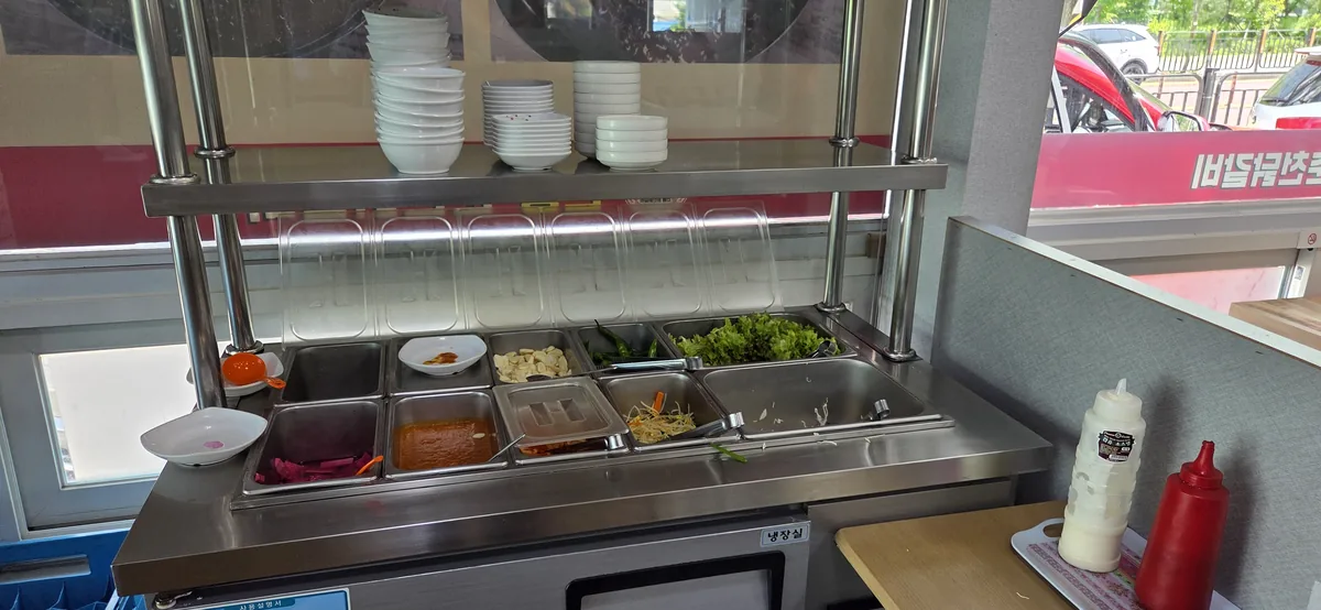 A self-refill side dish bar, a convenient feature when considering Korean restaurant parking availability.