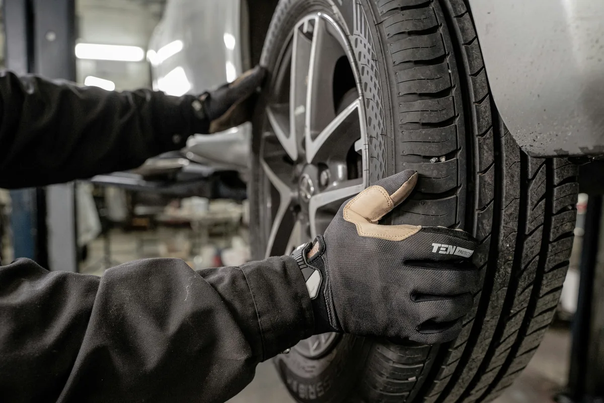 A mechanic pouring fresh engine oil during routine car maintenance in Korea.