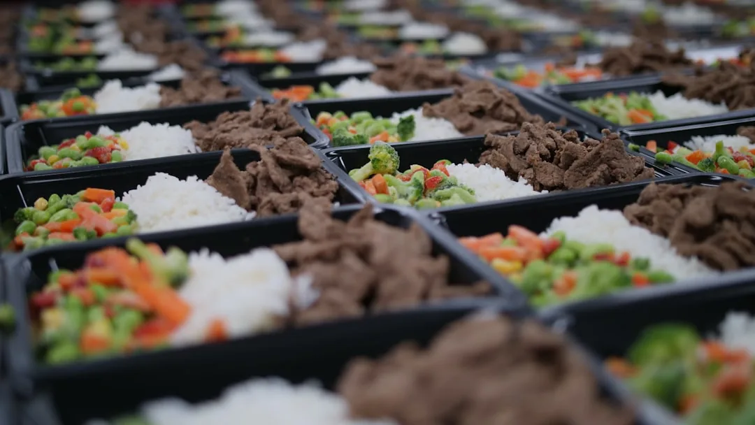 Assorted Korean dishes are neatly packed in individual plastic containers.