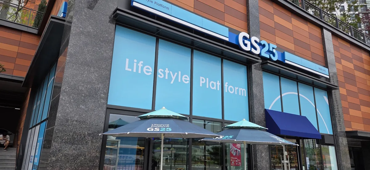 GS25 convenience store storefront with large windows displaying Lifestyle Platform branding and signage.