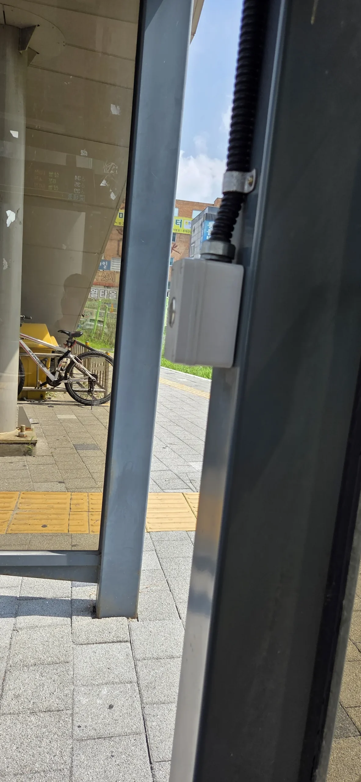 Wall switch on a bus stop pillar that turns on the ceiling fan